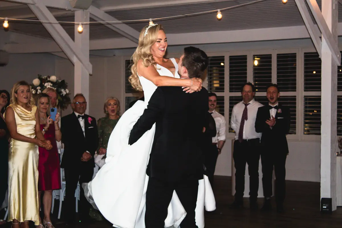 A groom lifting his bride during their first dance at Bramleigh Estate, showcasing premium Melbourne wedding DJ entertainment.