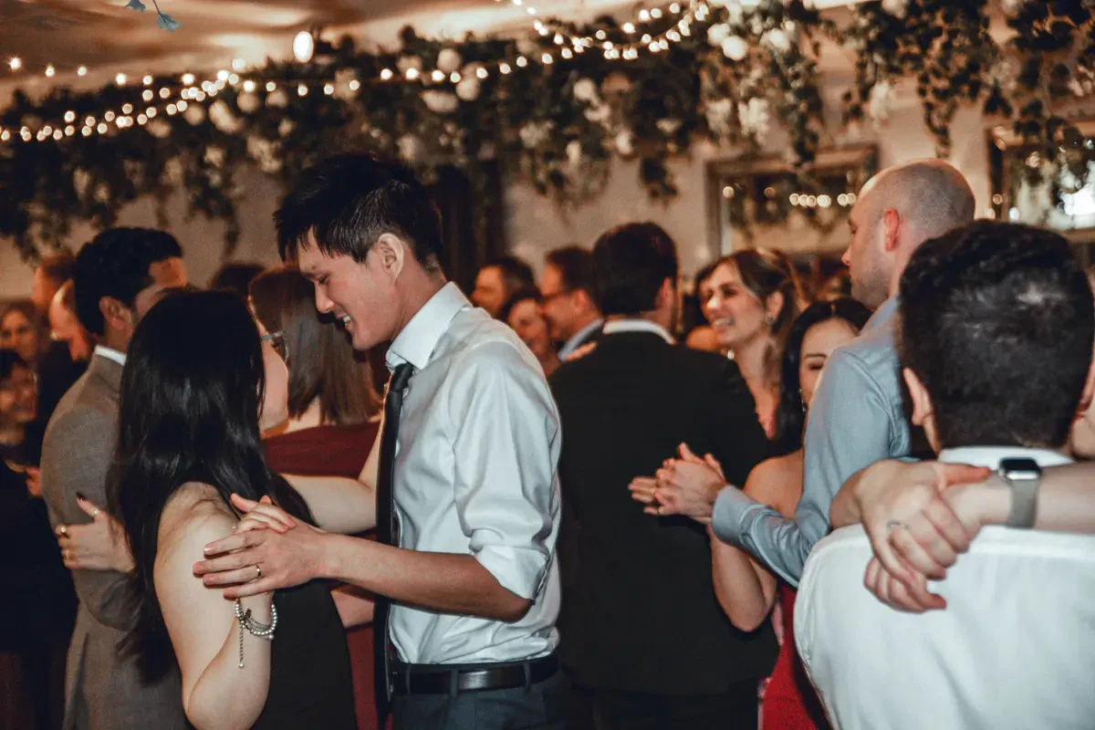 A packed, high-energy wedding dance floor with guests dancing to a professional Melbourne wedding DJ at Poet's Lane.